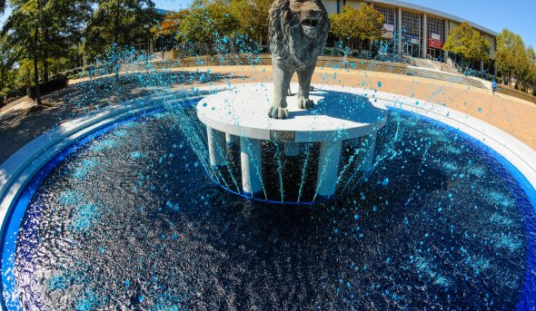 Lion statue in the middle of a waterfall 