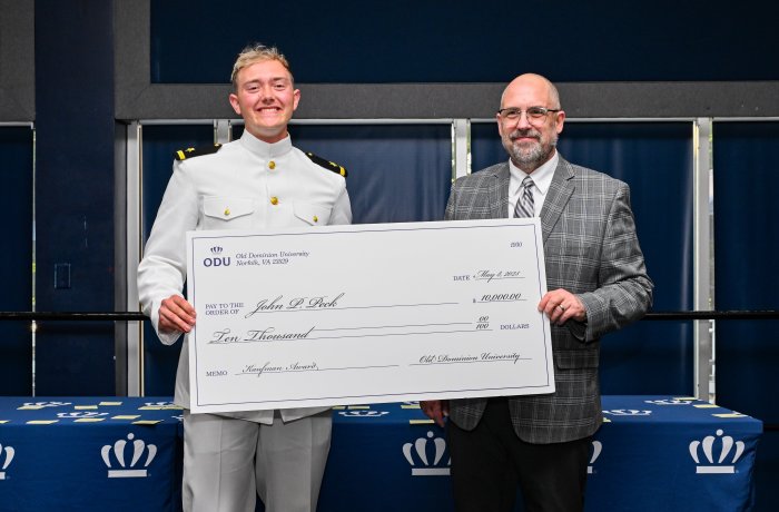 John Paul Peck and Dr. Brian Payne with a giant check