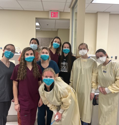 group of dental hygiene students posing for a photo 